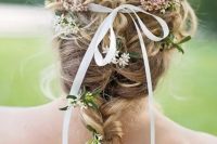 a braid with some curls and some blooms and greenery plus a thin ribbon is a great solution for a spring or summer wedding