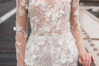a breathtaking fitting wedding dress in nude and with white floral applique that cover the whole dress, so it seems to be blooming
