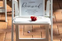 a chair in the ceremony space reserved for a deceased person who is loved and with a red rose to honor the person