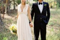 a chic empire waist wedding dress with a plunging neckline, no sleeves, a draped bodice and skirt for a casual bride