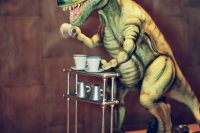 a chocolate cake in the shape of a 3-D T-Rex pouring coffee will surprise everyone and will definitely set the tone at the party