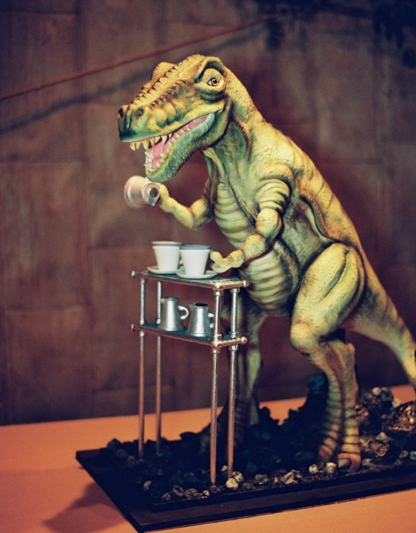 a chocolate cake in the shape of a 3 D T Rex pouring coffee will surprise everyone and will definitely set the tone at the party