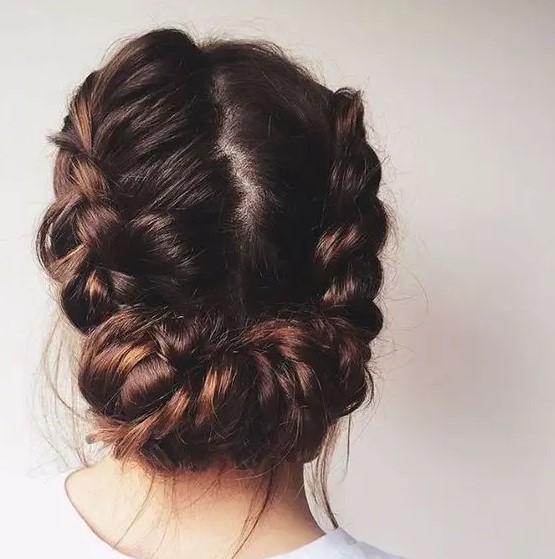 a cool braided low updo with a texture looks cool for a rustic or boho bride