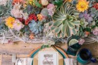 a cozy boho tablescape with a macrame runner and a folksy napkin, colorful plates and chargers, lush florals and succulents