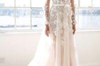 a deep V-neckline and long sleeves ivory wedding dress with matching floral appliques, a train and matching floral earrings
