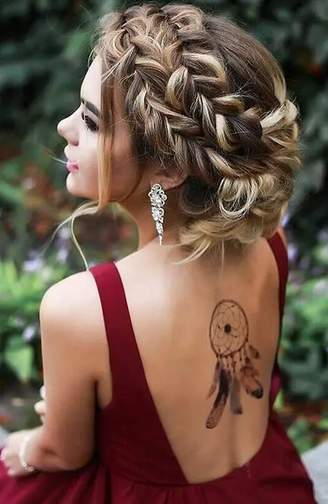 a double fishtail braided updo with some locks down looks very sexy and bold