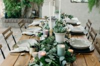 a eucalyptus table runner with succulents in pots, with pastel candles and tall white ones is super chic and edgy