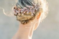 a fishtail braided updo accessorized with a rose gold hairpiece for a fall boho wedding