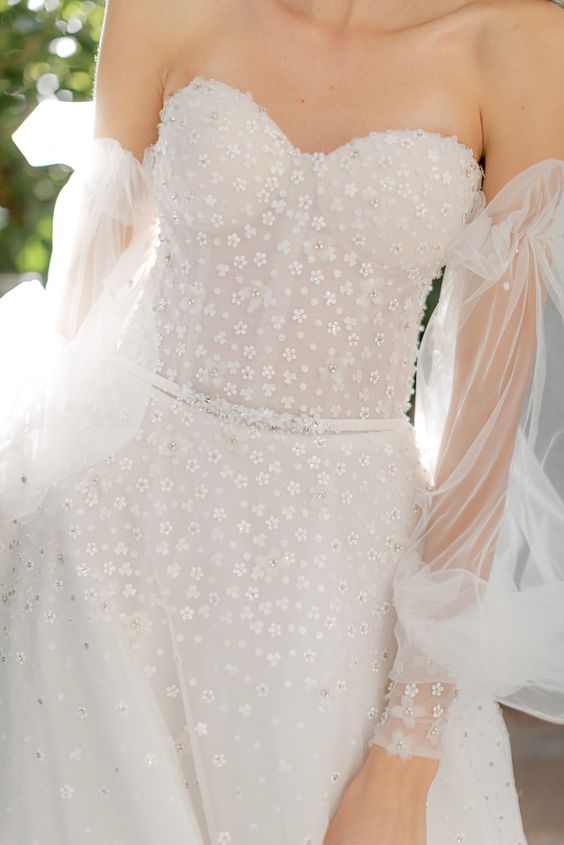 a girlish off the shoulder wedding dress with embellishments and floral appliques, with puff sleeves is a lovely idea