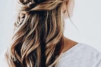 a half updo with a side braid and waves looks very soft and romantic and adds a slight boho feel to the look
