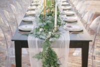 a lush eucalyptus and fern table runner combined with an airy and flowy fabric table runner