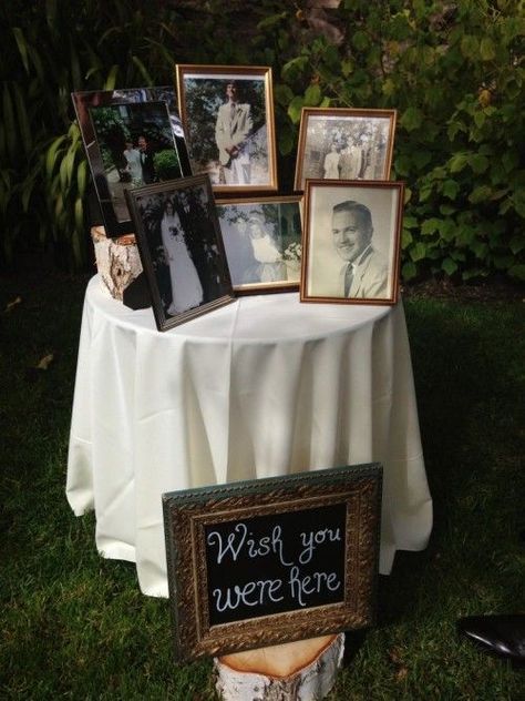 a memorial table with photos of the people who are gone and a chalkboard sign in a frame is a smart idea to rock