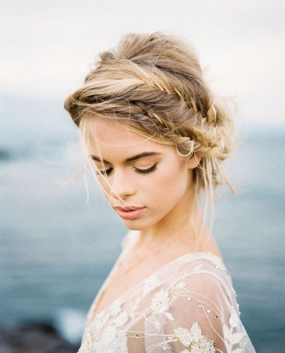 a messy low updo with a double fishtail braid and some hair down is a romantic idea