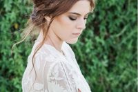 a messy textural updo with a dimensional braided halo and locks down is a great boho hairstyle
