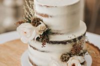 a naked wedding cake with white blooms and dired ones for a chic fall rustic wedding