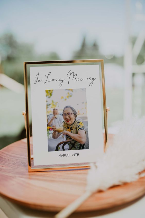 a photo memorial sign in a gold frame will be a nice and cool idea for any wedding
