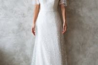 a polka dot A-line wedding dress with a sculptural bodice, short sleeves, a V-neckline and a short train