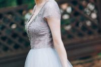 a purple A-line wedding dress with a lace bodice, an embellished neckline and a tulle skirt