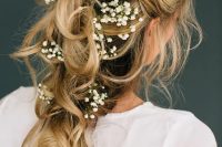 a romantic tousled bridal braid adorned with baby’s breath looks ethereal and is great for a boho bride
