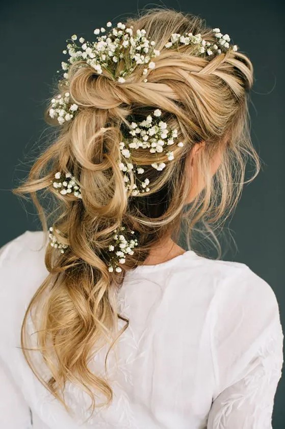 a romantic tousled bridal braid adorned with baby's breath looks ethereal and is great for a boho bride