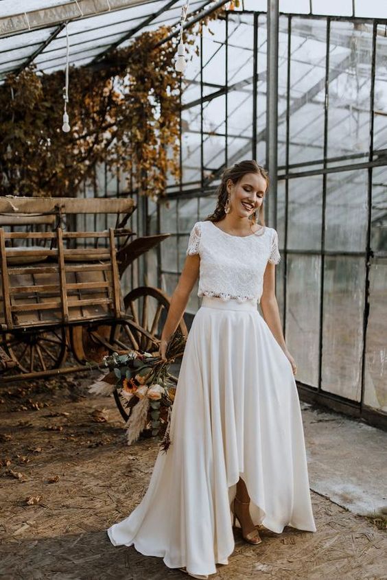 a romantic wedding separate with a lace crop top with short sleeves and a pleated high low skirt with a train