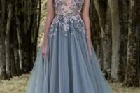 a slate blue illusion bodice wedding dress with blue and blush floral appliques and off the shoulder illusion sleeves