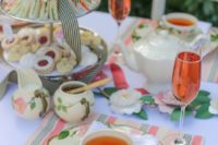 a spring tea party bridal shower with floral teaware, lots of sweets and rose is a cool idea