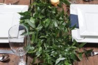 a very lush greenery table runner with candles is a chic idea for any modern wedding, it’s very refreshing