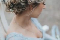 a wavy messy updo with blooms and thistles tucked in is ideal for a boho bride, for any season
