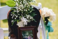 a wedding chair with blooms, cowboy boots and a family photo to remember those who you love but they are gone