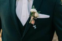 an elegant wedding boutonniere with white blooms and greenery and a photo in a frame is a cool solution to honor