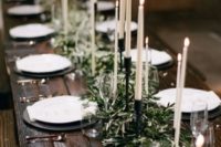 an olive branch wedding table runner with tall candles is an elegant and chic idea suitable for many weddings