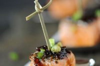 bourbon-glazed salmon appetizers with green onions on skewers is a chic and tasty idea for a spring wedding