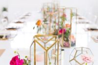 colorful blooms in geometric gold candle lanterns and in arrangements in vases for a spring bridal shower