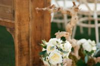 decorate the aisle with driftwood, air plants, white blooms and greenery to make it chic and beachy