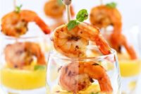 grilled shrimps on skewers with mango dip in cups are tasty, sweet and very fresh