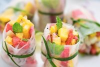 spring rolls with fresh watermelon, mango and pineapple salad plus herbs are delicious and refreshing