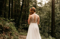 a beautiful A-line wedding dress with a halter neckline, a lace cutout back, a flowy skirt with lace inserts