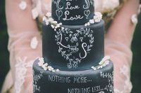a beautiful chalkboard wedding cake with chalking and some white blooms is a gorgeous idea for any wedding, here blooms are mostly about a spring celebration