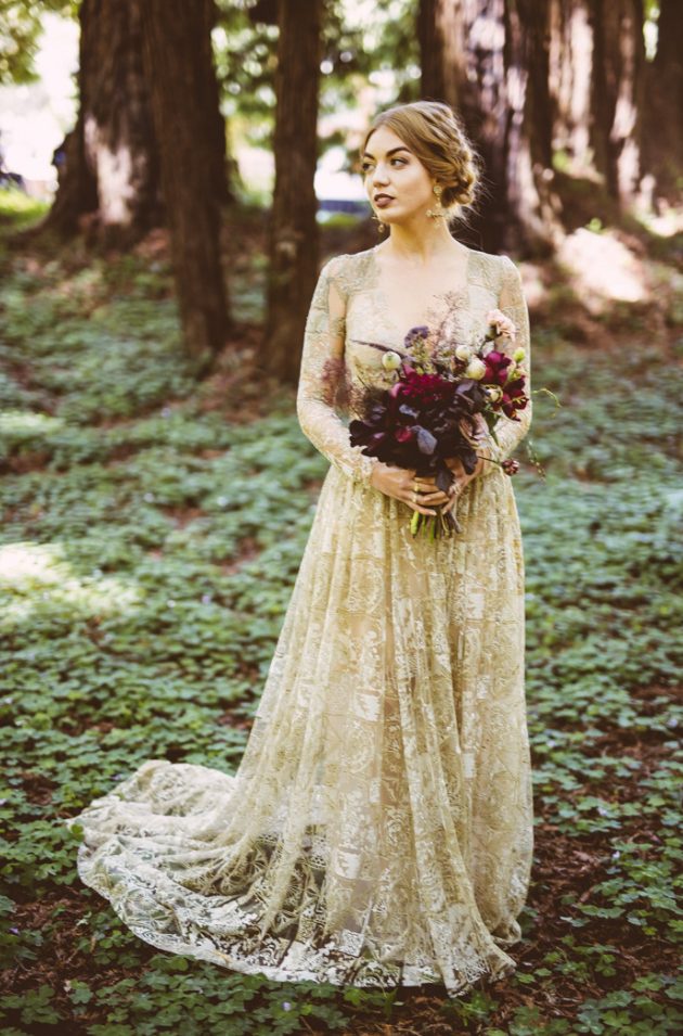 a beautiful gold lace wedding gown with a train, long sleeves and a V-neckline for a refined fall bride