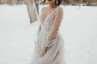a beautiful grey fully embellished wedding ballgown with a deep V neckline and sheer sleeves for a real ice queen