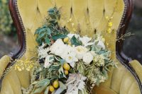 a beautiful lush and textural wedding bouquet of white blooms, greenery, blooming branches, fringe ribbons is a fab idea for fall or summer