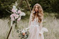 a blush A-line wedding dress with long sleeves and a V-neckline plus white lace