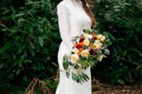 a boho lace fitting wedding dress, a high neckline, a train and a bold floral crown