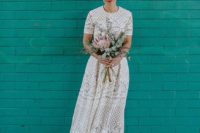 a boho lace high low wedding dress with a high neckline, short sleeves and burgundy lace up heels