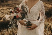 a boho lace wedding dress with a V-neckline, a cutut, bell sleeves and a fittign silhouette