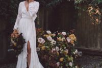 a boho lace wrap wedding dress with long sleeves and a slit plus a train and black boots for a touch of rock