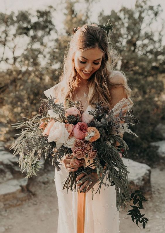 a boho summer wedding bouquet in pink, coffee, marigold, white and with greenery and pampas grass