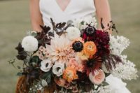 a bold fall boho wedding bouquet in blush, marigold, burgundy, white, with dark and neutral foliage