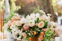a bright and vivacious wedding centerpiece of white, pink and rust blooms, greenery and kumquats is a gorgeous idea to rock